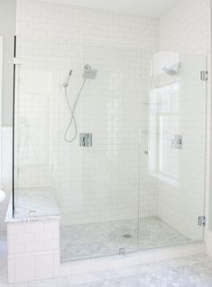 a walk in shower sitting next to a white sink