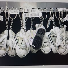 several pairs of shoes are hanging from chains