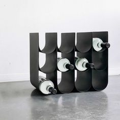 three wine racks are stacked on top of each other in the shape of letter u