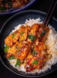 chicken and vegetable stir fry served on rice with chopsticks