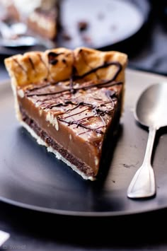 a piece of chocolate pie sitting on top of a metal plate next to a spoon