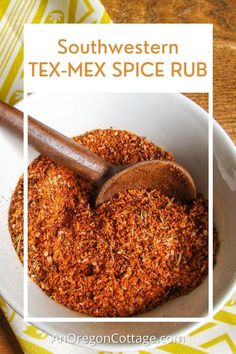 a white bowl filled with spices on top of a yellow and white table cloth next to a wooden spoon