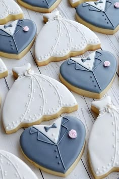 decorated cookies are arranged in the shape of grooms suits and tuxedo vests