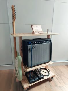 an electric guitar and amp stand on wheels