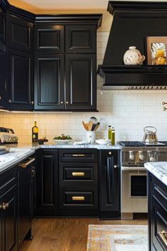 a kitchen with black cabinets and white counter tops