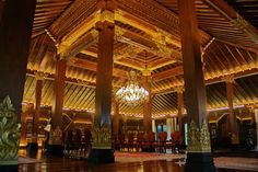 the inside of a large wooden building with chandelier