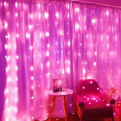 a chair sitting in front of a window covered in pink lights