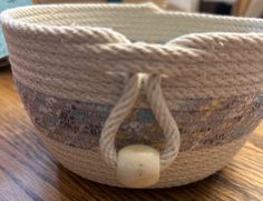 a woven basket sitting on top of a wooden table