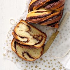 slices of cinnamon swirl bread sitting on top of a white table cloth next to a knife