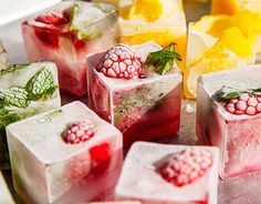 some ice cubes with raspberries and mint on them