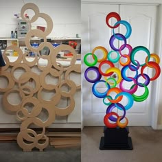 a man standing next to a sculpture made out of wood and plastic rings on top of each other