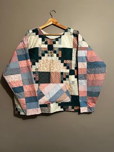 an old patchwork jacket hanging on a wall