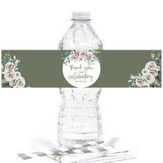 a water bottle with flowers on it and a ribbon around the top that says thank you for