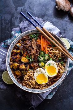 an overhead view of a bowl of ramen with chopsticks on the side