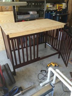 a workbench in a garage with tools on the floor