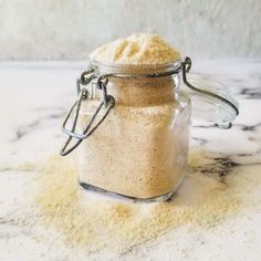 a jar filled with sand sitting on top of a counter