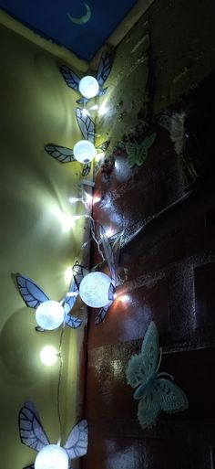 some fairy lights are hanging on the wall