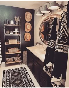 a black and white rug in a bathroom next to a sink with a mirror above it