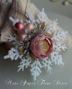 a close up of a snowflake decoration on a pillow with ornaments around it