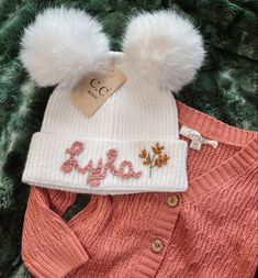 a pink sweater and white pom - pom hat