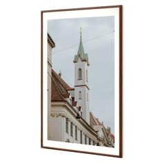 an old church with a steeple in the background framed wall art print by person