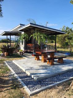 a picnic area with tables and benches under a canopy