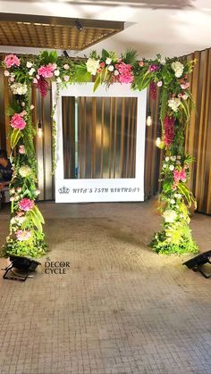 an entrance decorated with flowers and greenery