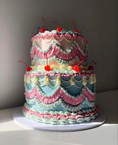 a three tiered cake with pink and blue icing