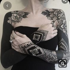 a woman with tattoos on her arms and arm