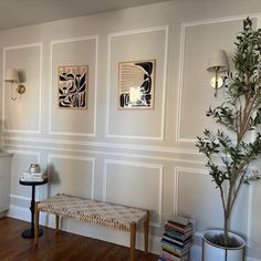 a living room with white walls and wood floors