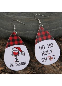 two pairs of earrings with the words i'm drunk and santa clause on them