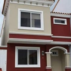 a red house with white trim and windows