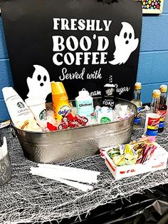 a table topped with lots of food and drinks next to a sign that says freshly bood'd coffee