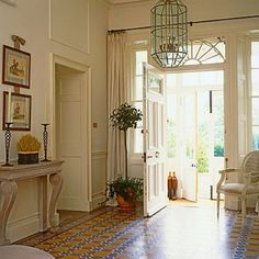 a living room filled with furniture next to a doorway