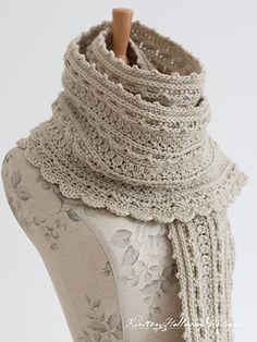 a mannequin wearing a white lace scarf