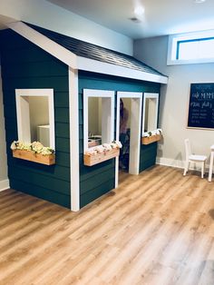 a child's room with bunk beds made out of wood and green paint on the walls