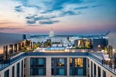 the view from an apartment building in washington, d c at sunset or dawn with the capitol building in the background