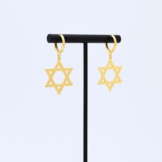 Embrace tradition, elegance, and faith with our Star of David earrings. Whether for yourself or as a cherished gift, these earrings are a symbol that endures through time, offering a connection to your beliefs and a touch of beauty to your style.✨ Finish: White Gold Dipped or Gold Dipped Size: 1.3in*0.8in Ready to ship in 1 - 3 business days To ensure lasting beauty and shine, follow these simple care instructions: * Avoid Contact with Water: Remove before swimming, showering, or participating i Star Dangle Earrings, Hebrew Israelite, Jewish Star, Jewish Jewelry, Hanukkah Gifts, Huggie Earrings, Gold Dipped, Star Of David, Jewelry Earrings Hoops