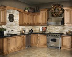 a large kitchen with wooden cabinets and black counter tops, stainless steel appliances and an oven