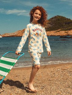 The D062 Surfing Camille Rash Guard is a playful yet protective children's swimwear piece featuring a polka dot pattern with Camille prints, perfect for summer water activities. The garment is crafted from a premium nylon-spandex blend with UPF50+ protection, blocking 99% of harmful UV rays during beach, pool, or stream activities. Its comfortable round neck design and excellent elasticity ensure unrestricted movement, while the specialized fabric requires gentle care including hand washing in c Kids Surfing, Summer Water Activities, Childrens Swimwear, Round Neck Design, Summer Water, Kids Swimwear, Water Activities, Polka Dot Pattern, Beach Pool