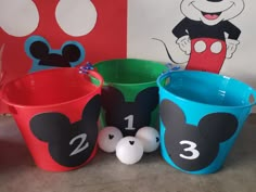 three buckets with numbers and mickey mouse faces on them