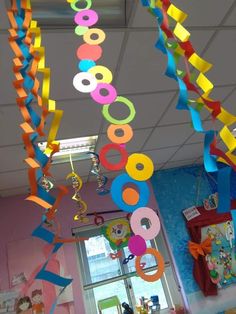 some colorful streamers hanging from the ceiling in a school room with a window and door