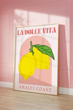 a poster with two lemons on it in front of a pink wall and wooden floor