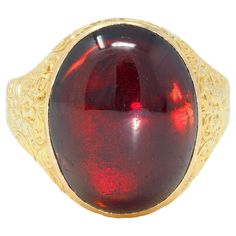 Centering an oval-shaped garnet cabochon measuring 13.5 x 17.0 mm Transparent dark/medium red in color - bezel set With ornately engraved surround and shank Depicting scrolling florals and birds Stamped with British assay marks for 18 karat gold With maker's mark Circa: 1900 Ring size: 7 1/2 and sizable Measures north to south 18.5 mm and sits 8.0 mm high Total weight: 10.2 grams Stock Number: We-12458 Luxury Gold Engraved Ring With Cabochon, Luxury Garnet Oval Cabochon Rings, Large Gemstone Rings, Bird Stamp, Gold Floral, Signet Ring, Makers Mark, Beautiful Jewelry, Garnet