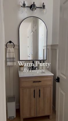 a bathroom vanity with a mirror above it and the words warm putty in front of it