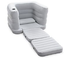 an inflatable sofa with pillows on the back and footrests attached to it