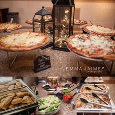 several different types of pizzas and other food items on a table with lights in the background