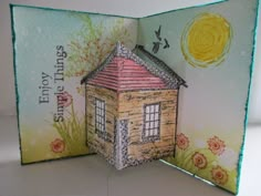 an open card with a small house on it