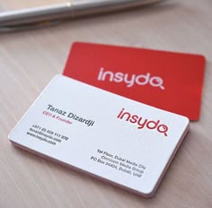 two business cards sitting on top of a table