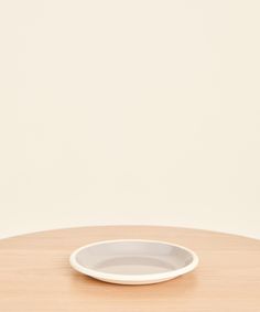 a white plate sitting on top of a wooden table